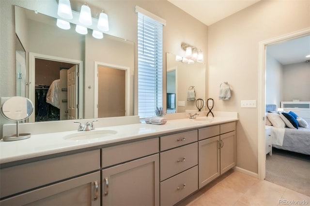 6362 Lythmore Grv, Colorado Springs, CO 80927 - bathroom with double vanity, tile patterned flooring, ensuite bath, a spacious closet, and baseboards