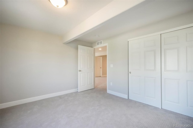 6362 Lythmore Grv, Colorado Springs, CO 80927 - unfurnished bedroom with light carpet, baseboards, a closet, and beamed ceiling