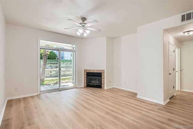 8500 E Jefferson Unit 3C, Denver, CO 80237 - unfurnished living room with light wood-style floors, a ceiling fan, baseboards, and a fireplace