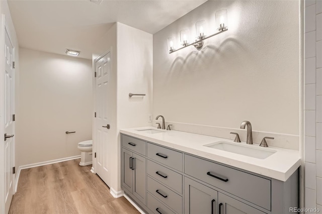 8500 E Jefferson Unit 3C, Denver, CO 80237 - full bath with wood finished floors, toilet, double vanity, and baseboards