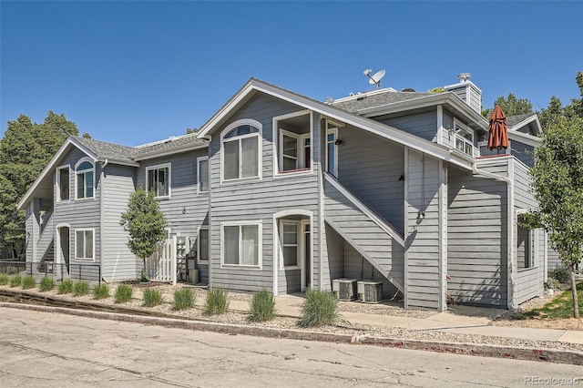 8500 E Jefferson Unit 3C, Denver, CO 80237 - view of front of property with central AC and a chimney