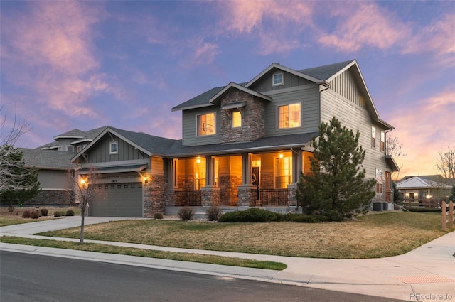 craftsman-style house featuring board and batten siding, a porch, and stone siding