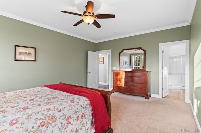 carpeted bedroom with ensuite bathroom, ceiling fan, baseboards, and ornamental molding