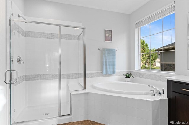 full bathroom featuring a shower stall, tile patterned flooring, vanity, and a garden tub
