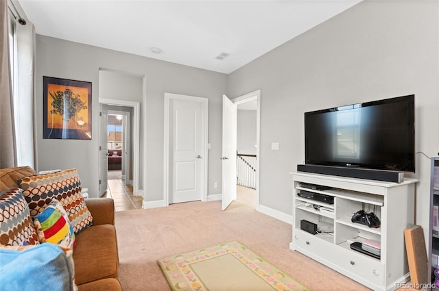 carpeted living room featuring baseboards and visible vents