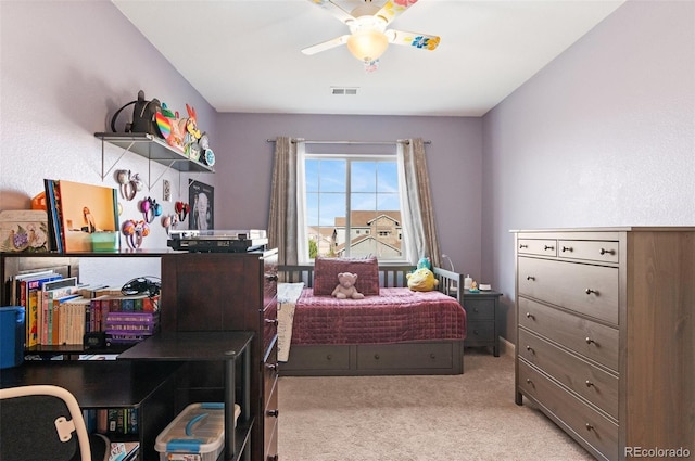 carpeted bedroom featuring visible vents and a ceiling fan