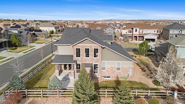 exterior space featuring roof with shingles, a residential view, and fence private yard