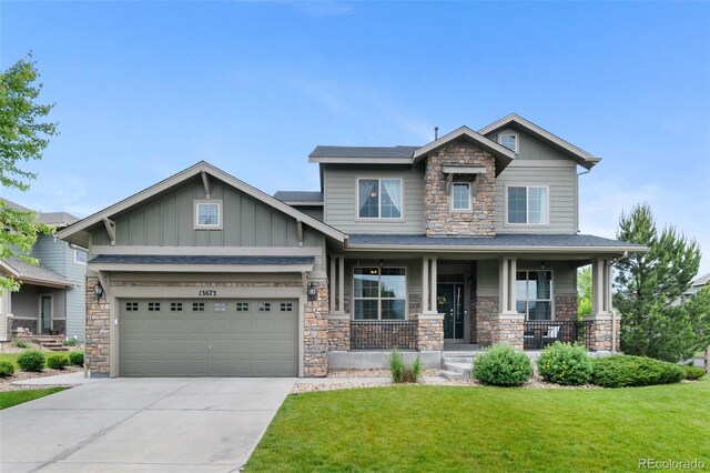 13673 Osage St, Broomfield, CO 80023 - craftsman-style home with stone siding, board and batten siding, covered porch, and driveway