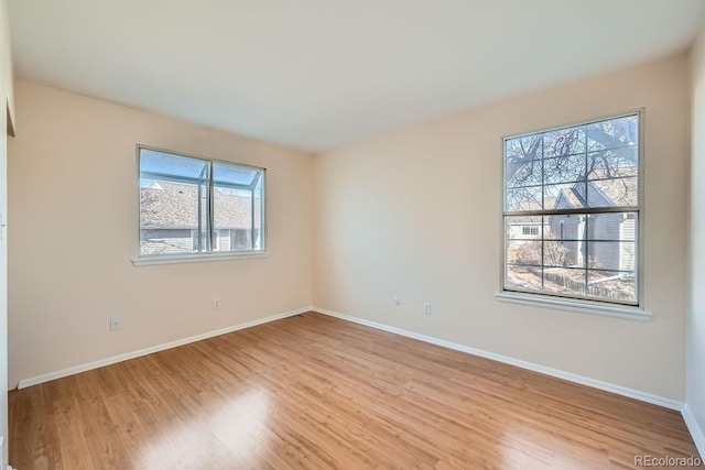 spare room featuring light wood-type flooring