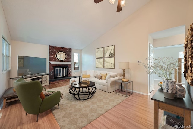 living room with ceiling fan, a fireplace, high vaulted ceiling, and wood-type flooring