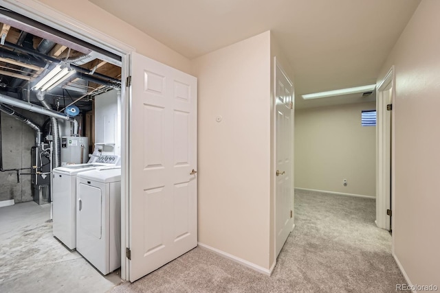 clothes washing area featuring separate washer and dryer and light colored carpet