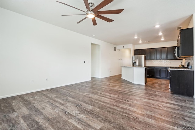 unfurnished living room with ceiling fan and dark hardwood / wood-style floors