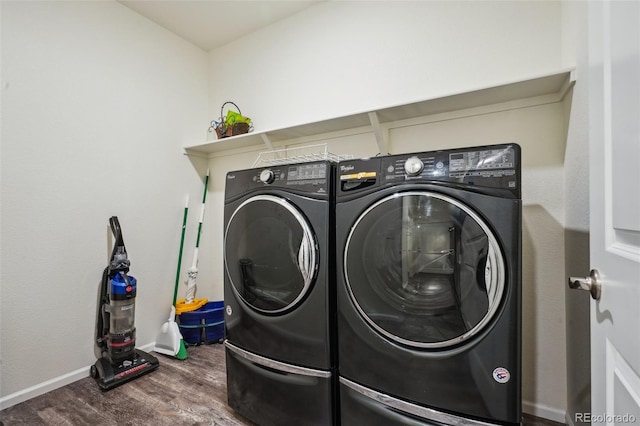 laundry area featuring separate washer and dryer and dark hardwood / wood-style flooring