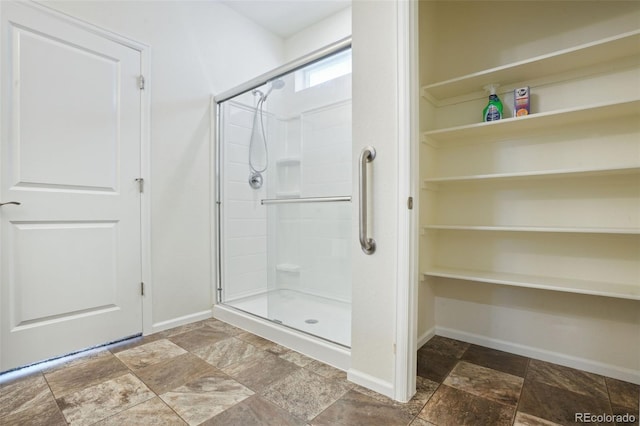 bathroom featuring a shower with door