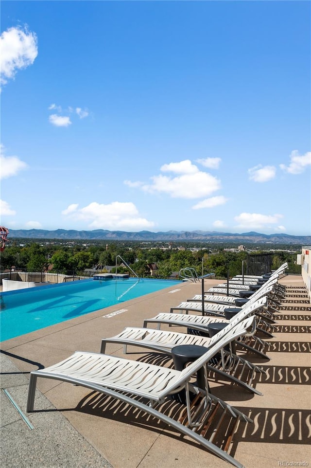 view of swimming pool with a mountain view