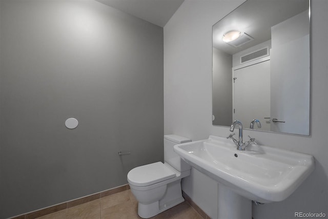 bathroom with sink, tile patterned floors, and toilet