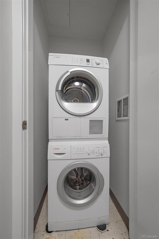 laundry room with stacked washer / dryer