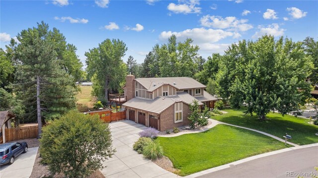 11796 W 53rd Pl, Arvada, CO 80002 - view of front of home featuring fence, an attached garage, a tile roof, a front lawn, and concrete driveway