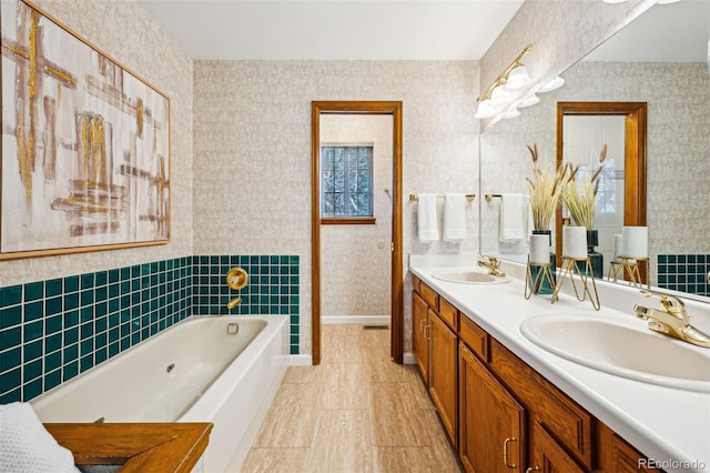 bathroom featuring vanity and a tub