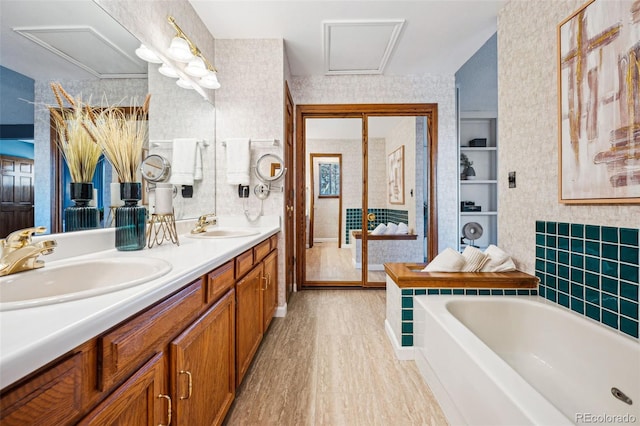 bathroom with vanity, a bathing tub, and hardwood / wood-style floors