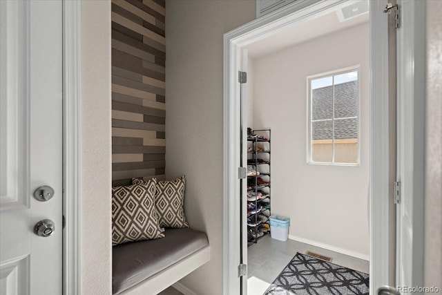 bathroom featuring tile patterned flooring, visible vents, and baseboards
