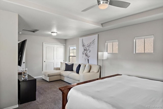 carpeted bedroom with a closet, attic access, and baseboards