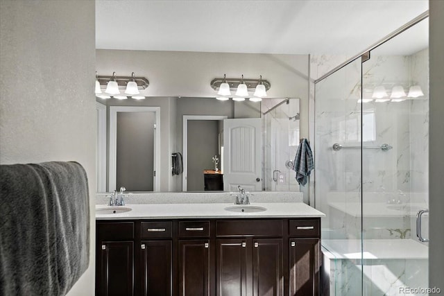 bathroom featuring double vanity, a sink, and a marble finish shower