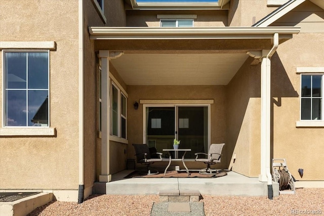 exterior space with a patio and stucco siding