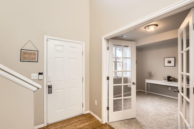 foyer featuring french doors and baseboards