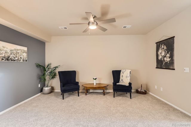 sitting room featuring baseboards, a ceiling fan, visible vents, and carpet floors