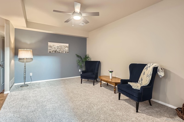 sitting room with baseboards, a ceiling fan, and carpet