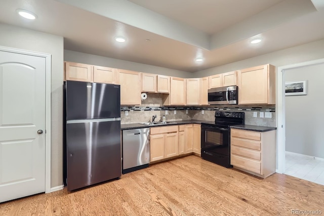 kitchen featuring light wood-type flooring, appliances with stainless steel finishes, light brown cabinetry, and recessed lighting