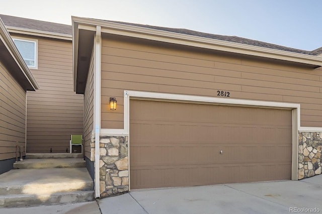 garage featuring concrete driveway