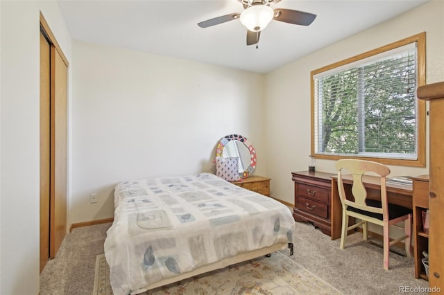 bedroom featuring carpet floors, ceiling fan, and a closet