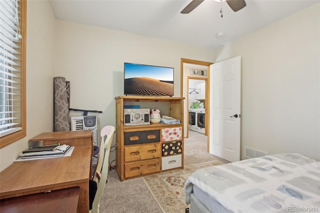 bedroom featuring separate washer and dryer, light carpet, a ceiling fan, and visible vents