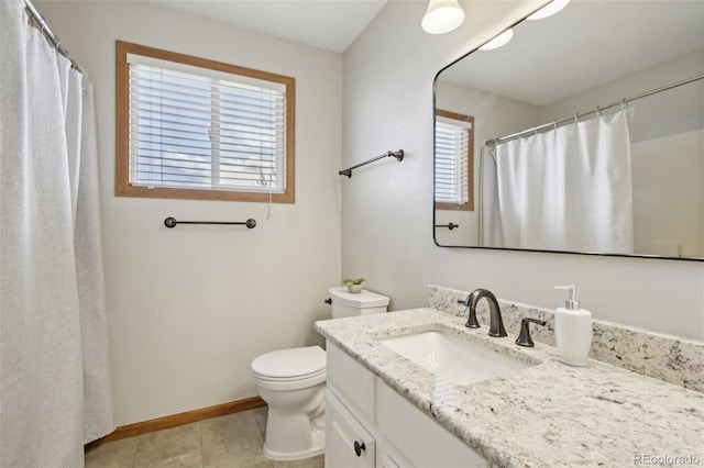 bathroom featuring a shower with curtain, vanity, tile patterned floors, baseboards, and toilet