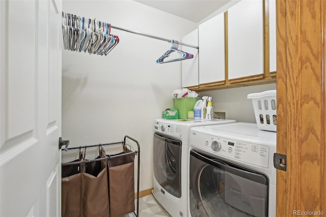 laundry area featuring cabinet space and washing machine and clothes dryer