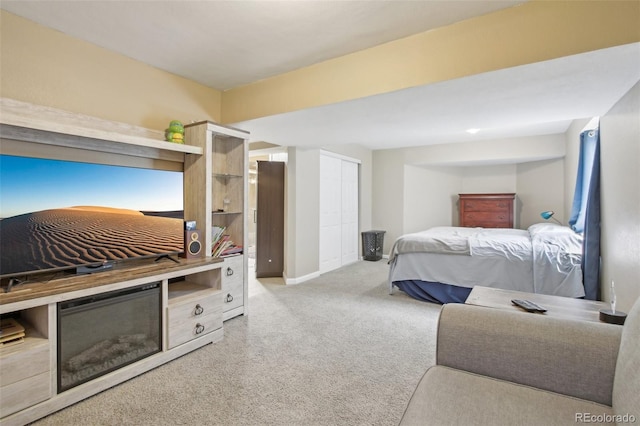 bedroom with carpet floors, baseboards, and a closet