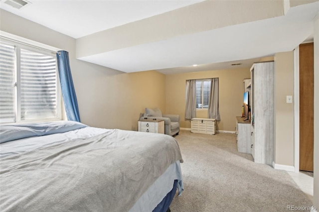 bedroom with light colored carpet, baseboards, and visible vents