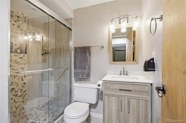 bathroom with vanity, a stall shower, and toilet