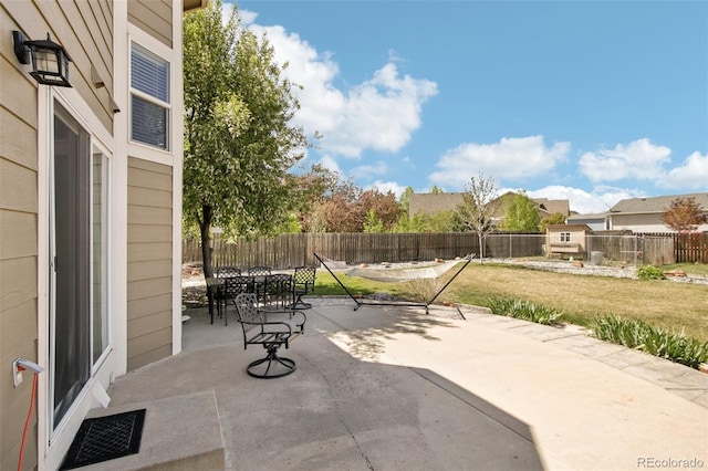 view of patio / terrace with a fenced backyard, outdoor dining area, and visible vents