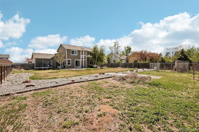 view of yard with a fenced backyard and a trampoline