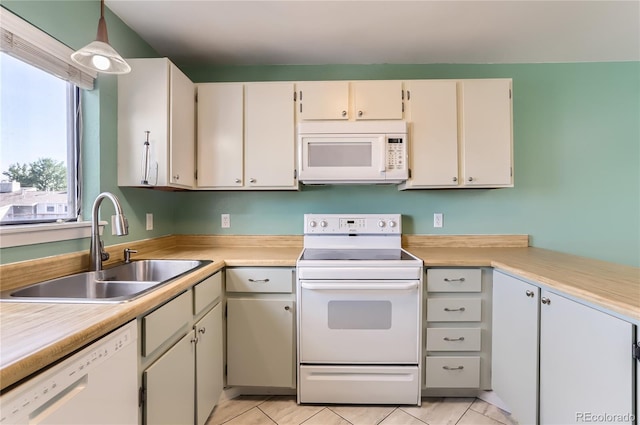 8635 Clay St Unit 417, Westminster, CO 80031 - kitchen with white appliances, a sink, light countertops, and light tile patterned flooring