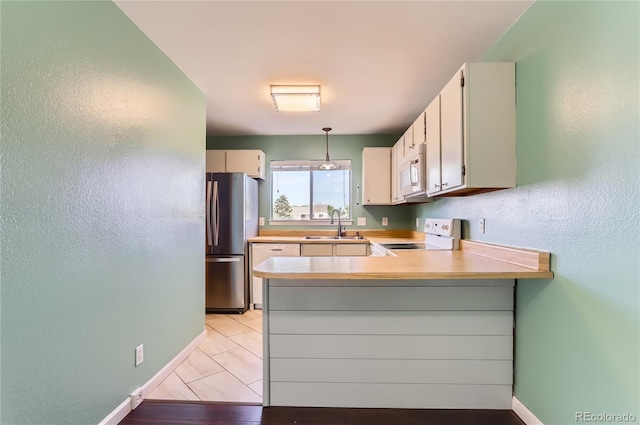 8635 Clay St Unit 417, Westminster, CO 80031 - kitchen featuring white appliances, baseboards, a sink, a peninsula, and a textured wall