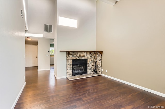 8635 Clay St Unit 417, Westminster, CO 80031 - unfurnished living room with a high ceiling, wood finished floors, baseboards, and a fireplace