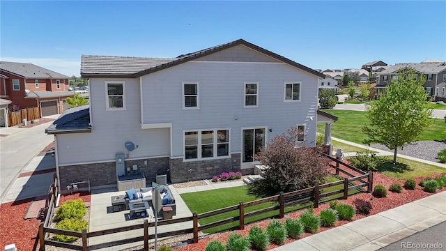 10016 Hough Pt, Parker, CO 80134 - back of property with a residential view, stone siding, outdoor lounge area, and a patio area