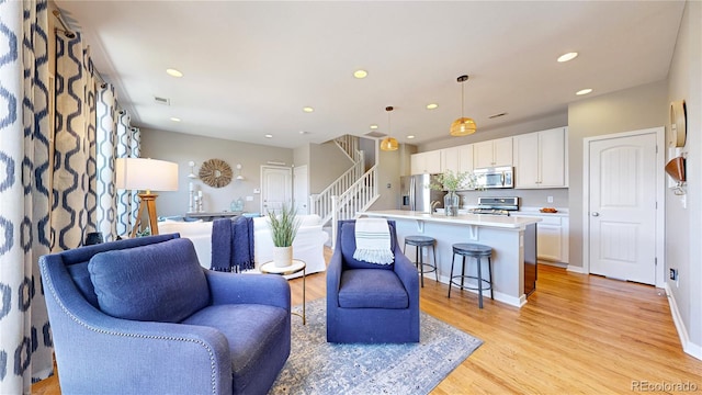 10016 Hough Pt, Parker, CO 80134 - living room with light wood-style floors, recessed lighting, and stairs