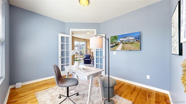 10016 Hough Pt, Parker, CO 80134 - home office featuring wood finished floors, baseboards, and french doors