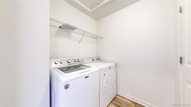 10016 Hough Pt, Parker, CO 80134 - laundry room featuring washer and dryer, light wood-type flooring, and baseboards