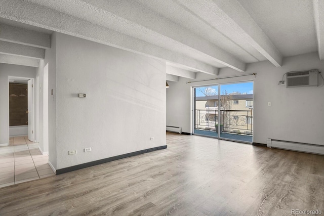 unfurnished room with a wall unit AC, wood finished floors, a baseboard radiator, beam ceiling, and a textured ceiling